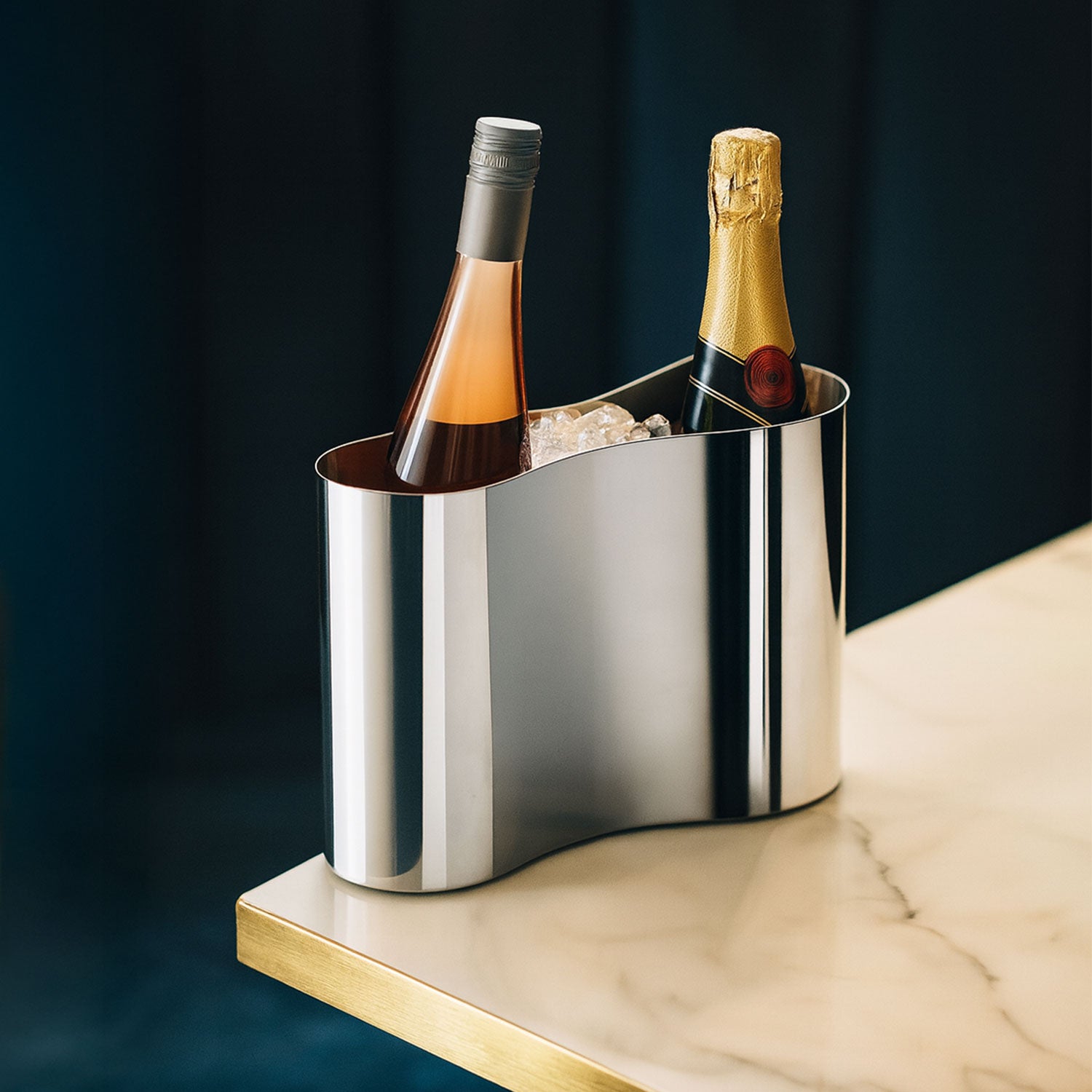 dubbele wijnkoeler met ijs op marmeren tafel met blauwe achtergrond